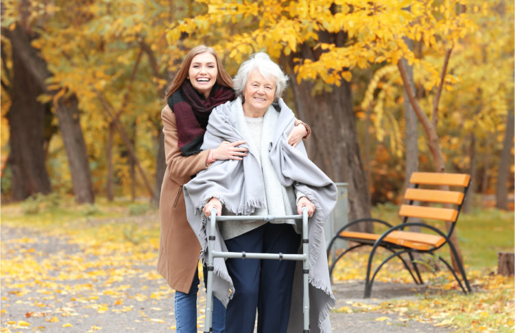 elder woman with caregiver outdoors