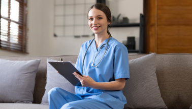 Smiling female healthcare worker holding a clipboard